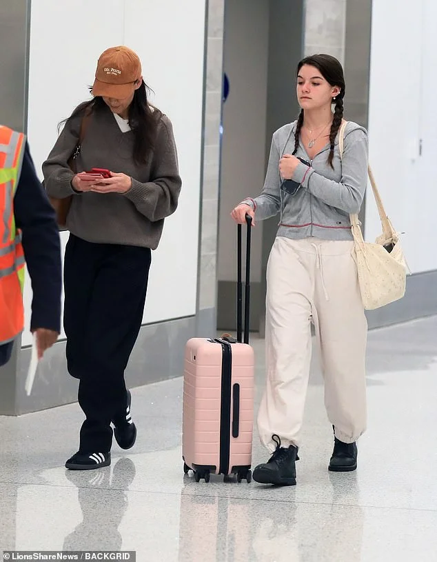 Fashionable family: Katie Holmes and daughter Suri Cruise leave LA in casual yet chic outfits.