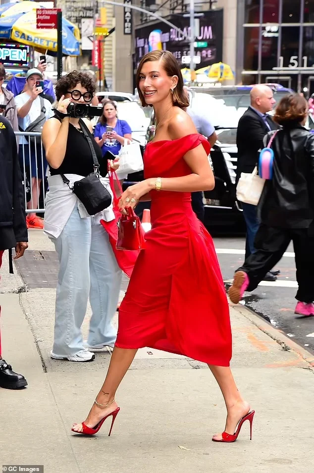 Hailey Bieber’s Striking NYC Appearance: Red Hot in Vivienne Westwood Dress, Ferragamo Bag, and Maison Ernest Mules on Aug 28, 2023