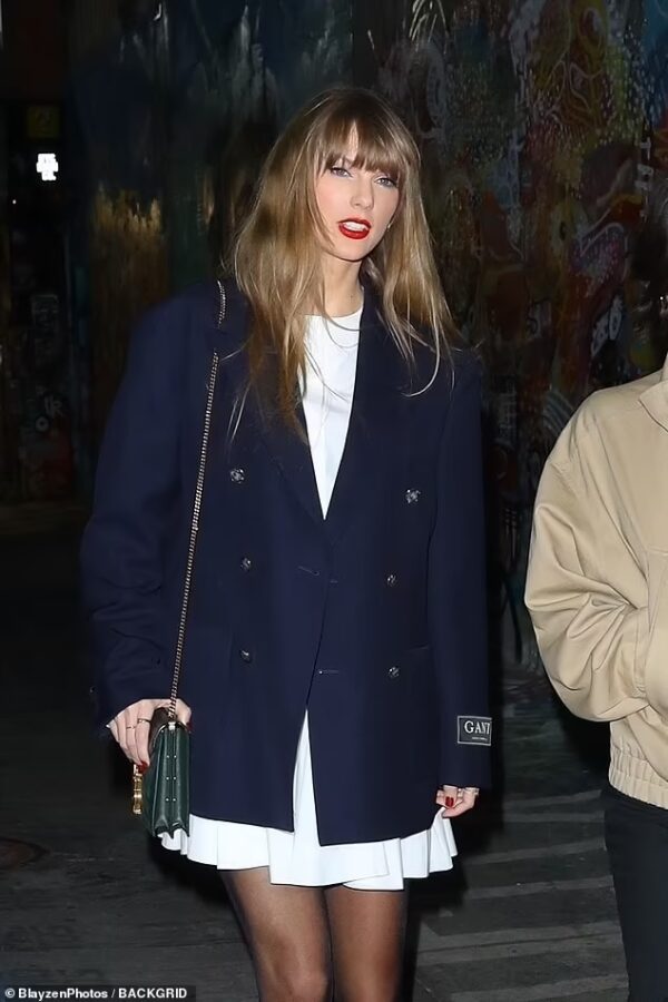Taylor Swift’s Preppy Chic Look: White Dress, Navy Blazer, and Loafers for a Stylish Girls’ Night in NYC  on Nov 13, 2023